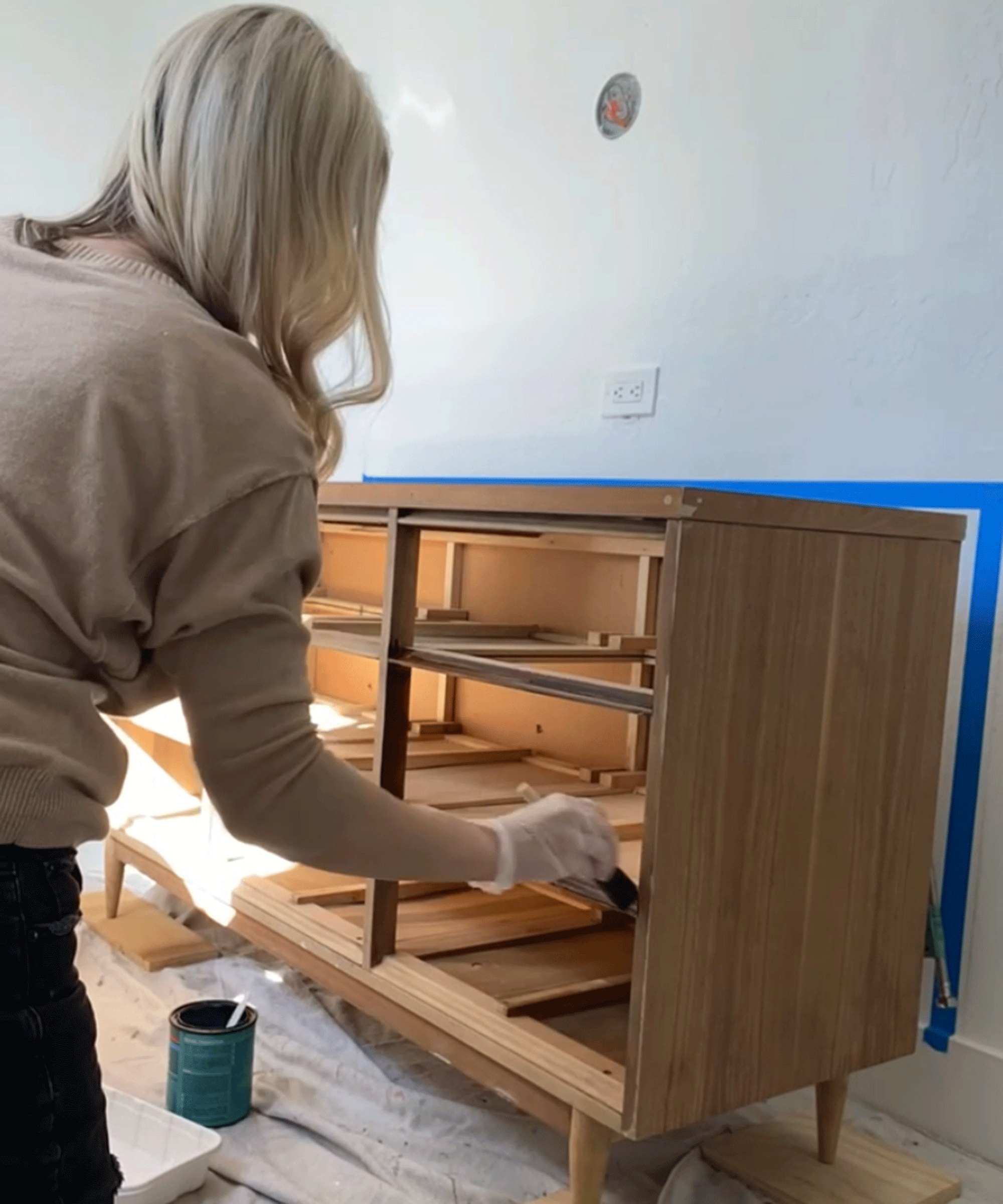 Brooke Waite treating wooden dresser vanity with gel stain and polycrylic treatments