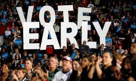 A &amp;quot;vote early&amp;quot; sign is displayed as former President Bill Clinton speaks at an Obama campaign rally in Youngstown, Ohio, on Oct. 29.
