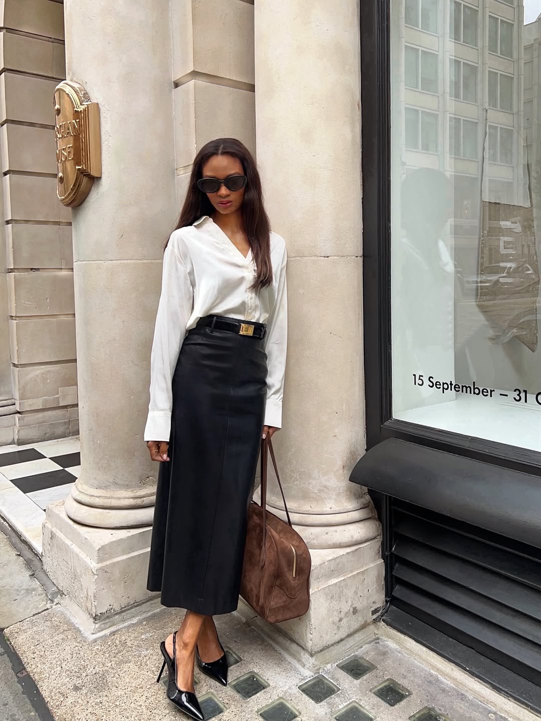 A woman standing on the street wearing the Saint Laurent Vend&amp;ocirc;me Slingback Pumps.
