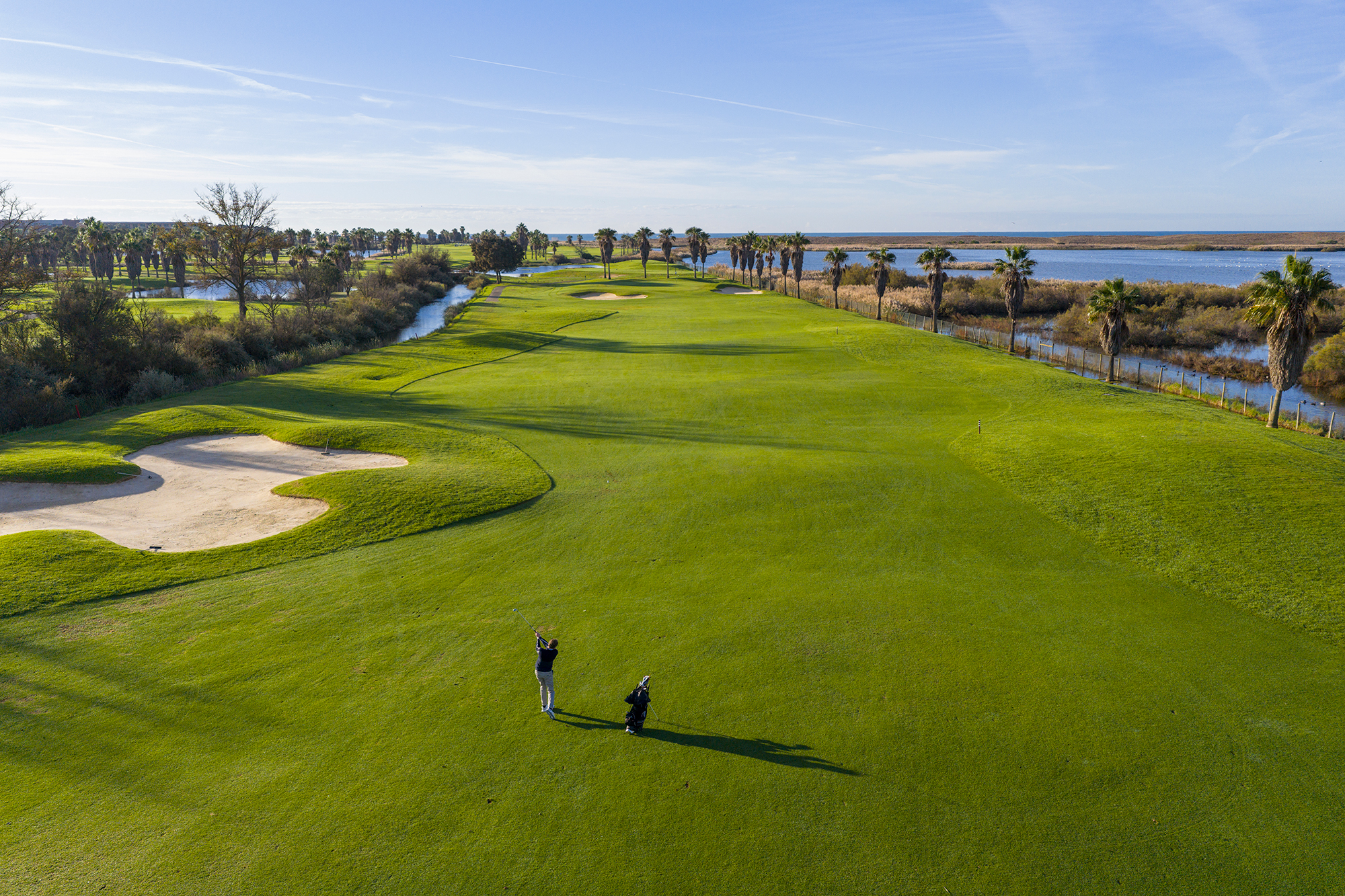 Drone shot of Keith Wood hitting a mid-iron shot to lay up for a scoring shot next with a wedge into the green