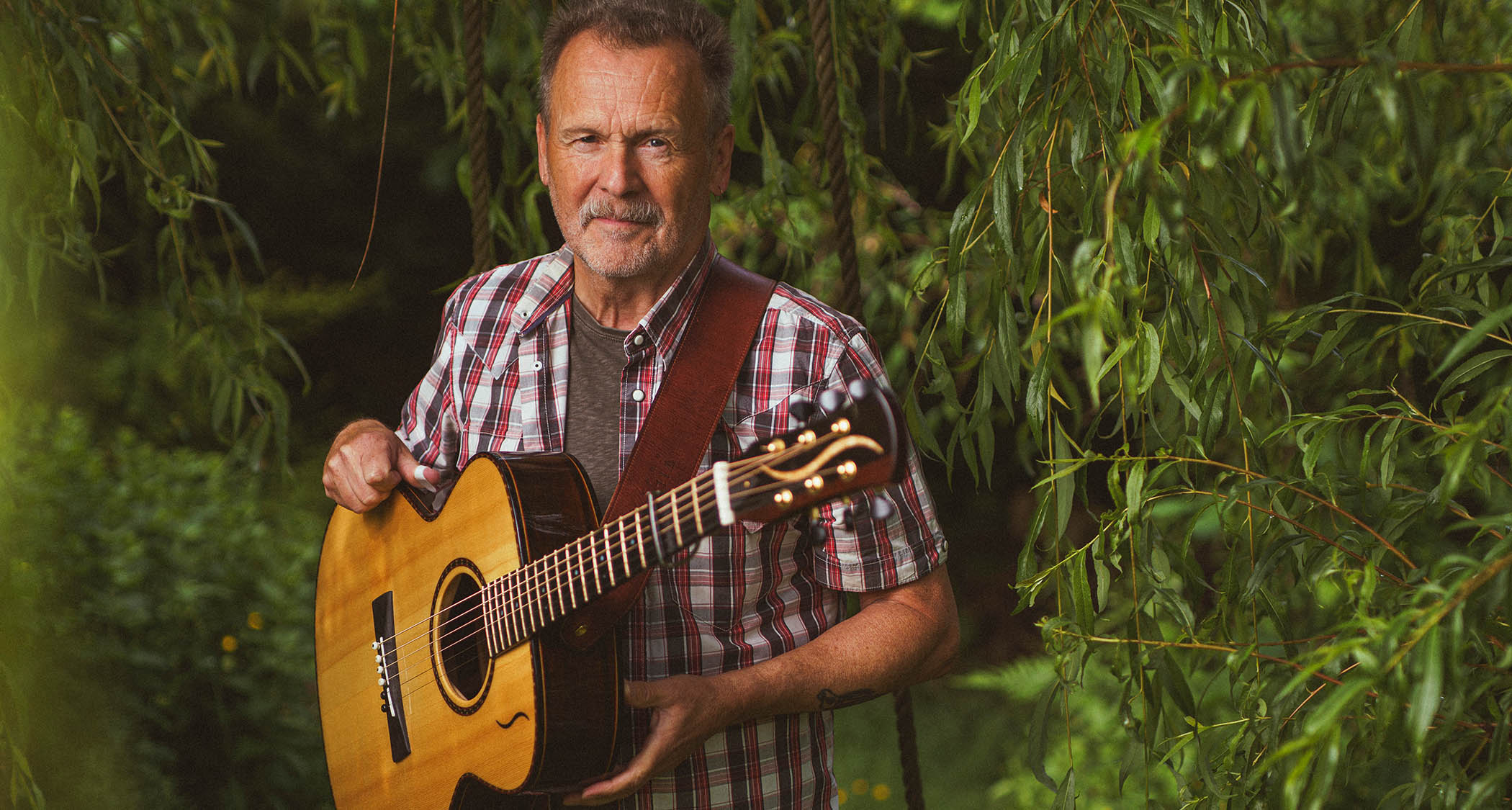 Martin Simpson at home with his acoustic guitar