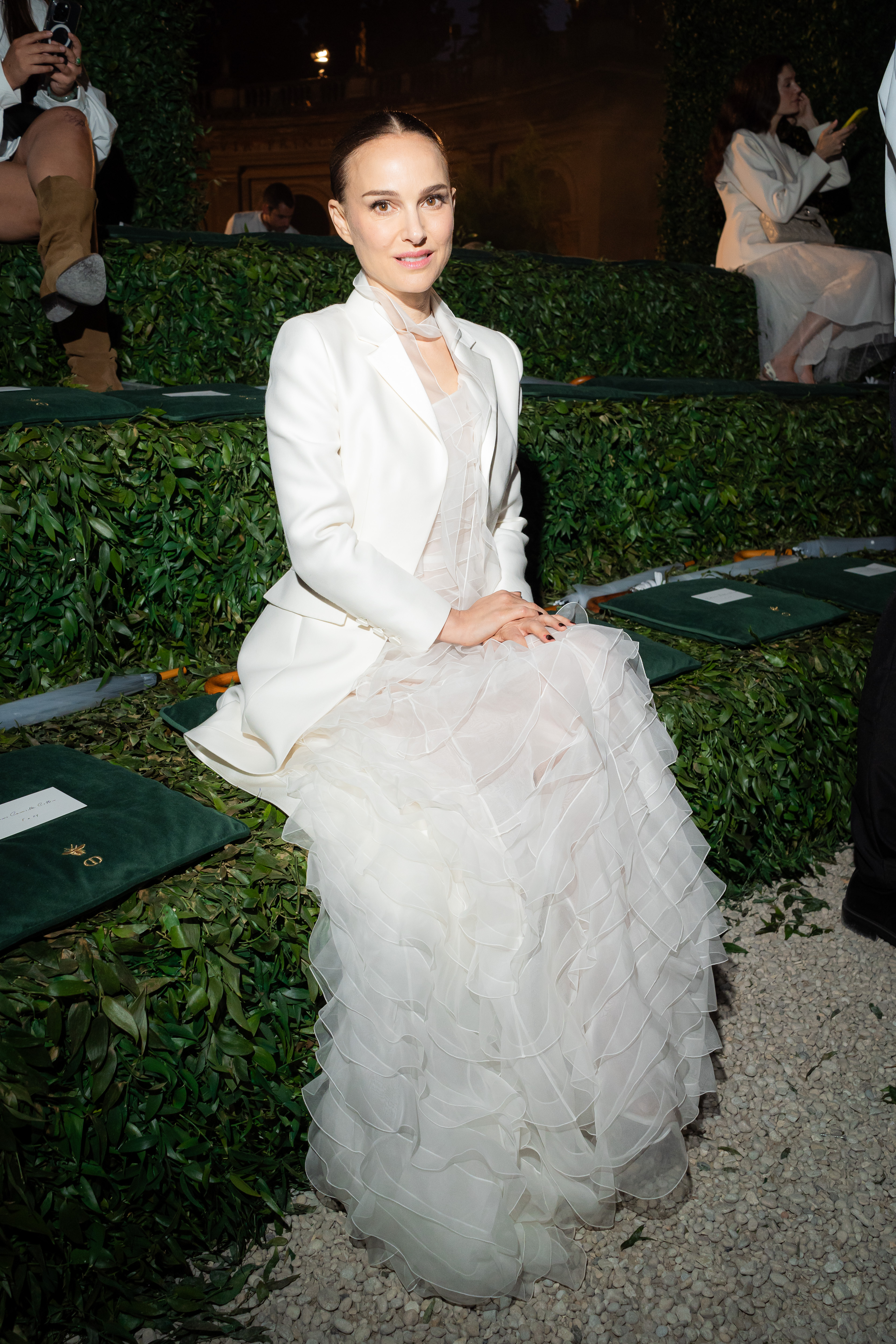 Natalie Portman with purple nails in a white gown at the Dior Cruise show.