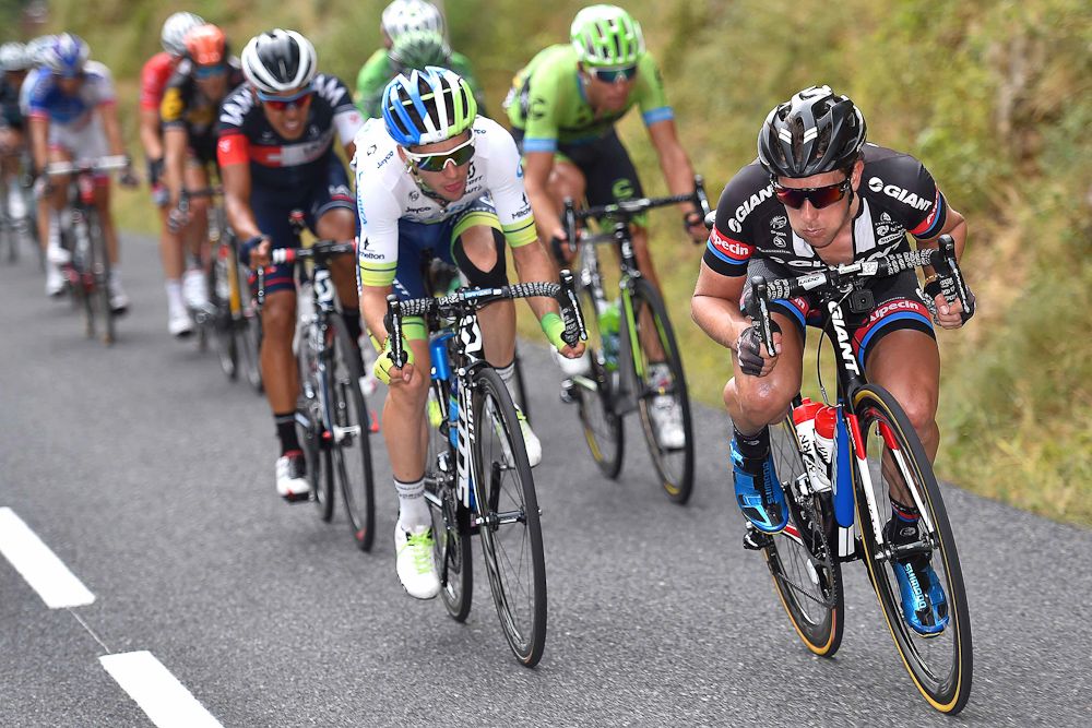 Riders push the pace on a descent during stage 14.