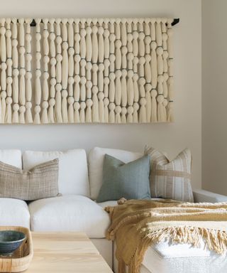 neutral coastal living room with a sculptural bead 3d art hanging