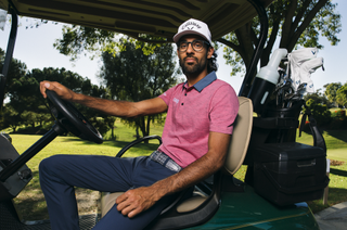 Akshay Bhatia sitting in a golf cart