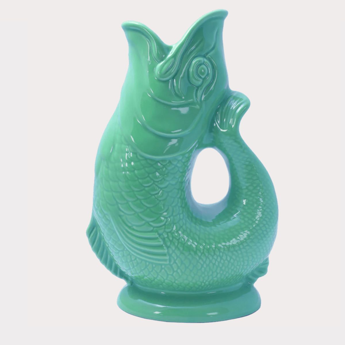 A teal blue fish jug