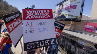 LOS ANGELES, CA - MAY 02: People picket outside of FOX Studios on the first day of the Hollywood writers strike on May 2, 2023 in Los Angeles. Scripted TV series, late-night talk shows, film and streaming productions are being interrupted by the Writers Guild of America (WGA) strike.
