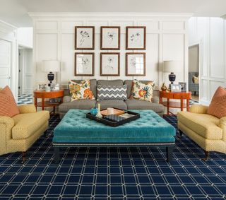 White wall paneled living room with yellow sofa and grey upholstered