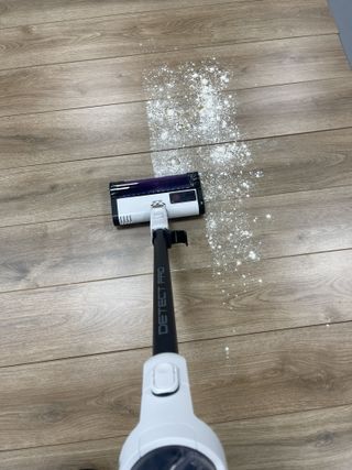 Shark Detect Pro Cordless vacuuming flour and sugar on wooden floor