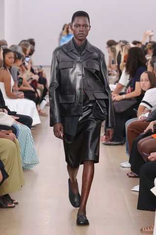 a Proenza Schouler model walks the spring/summer 2024 runway in mesh leather glove flats