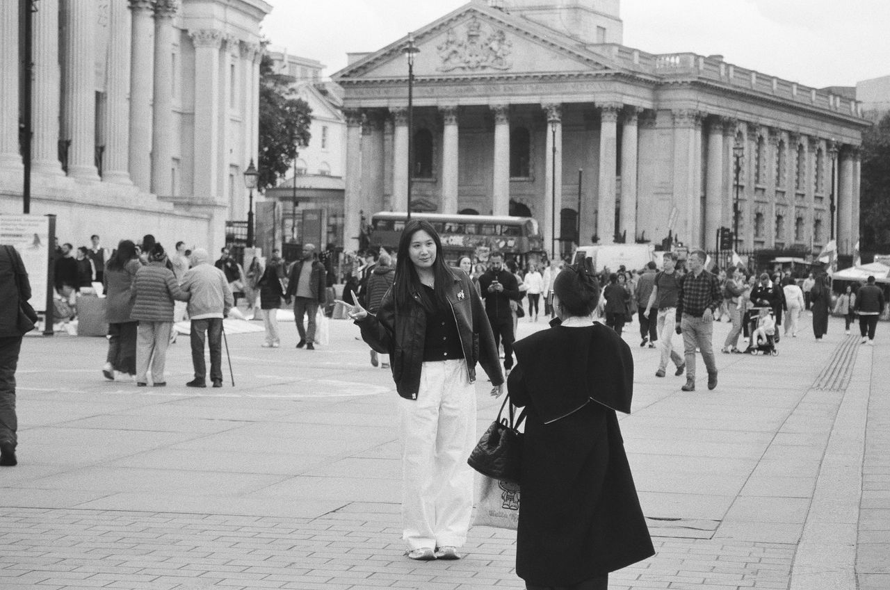 Sample image of Kentmere Pan 200 showing woman posing for a friend's photo at London's National Portrait Gallery