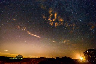 A Perseid meteor streaks over the beach at Corolla in Outer Banks, North Carolina in the early-morning hours of Aug. 5, 2016 in this image by photographer John Entwistle.