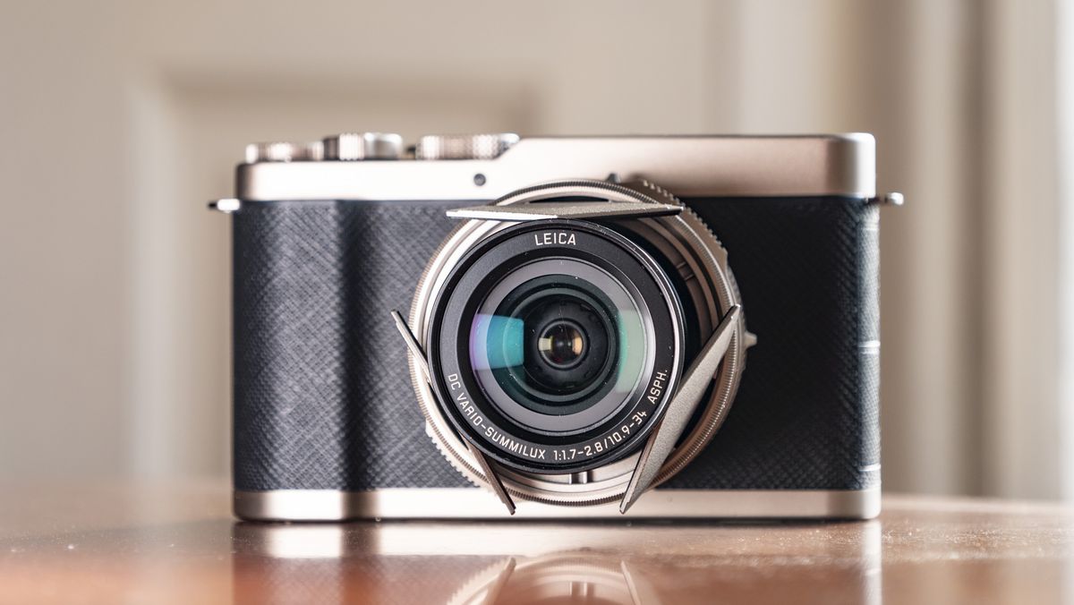 Titanium Gold special edition of the Panasonic Lumix L10 compact camera, on an antique wooden table
