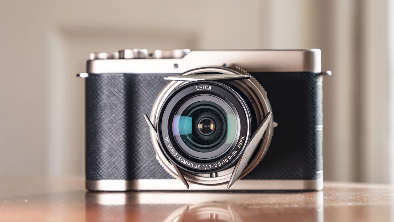 Titanium Gold special edition of the Panasonic Lumix L10 compact camera, on an antique wooden table
