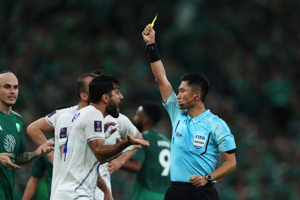 JEDDAH, SAUDI ARABIA - DECEMBER 02: Match Referee, Ma Ning, shows a yellow card to Mohammad Zobeir Niknafs of Esteghlal during the AFC Champions League Elite match between Al-Ahli and Esteghlal at King Abdullah Sports City Stadium on December 02, 2024 in Jeddah, Saudi Arabia. (Photo by Yasser Bakhsh/Getty Images)