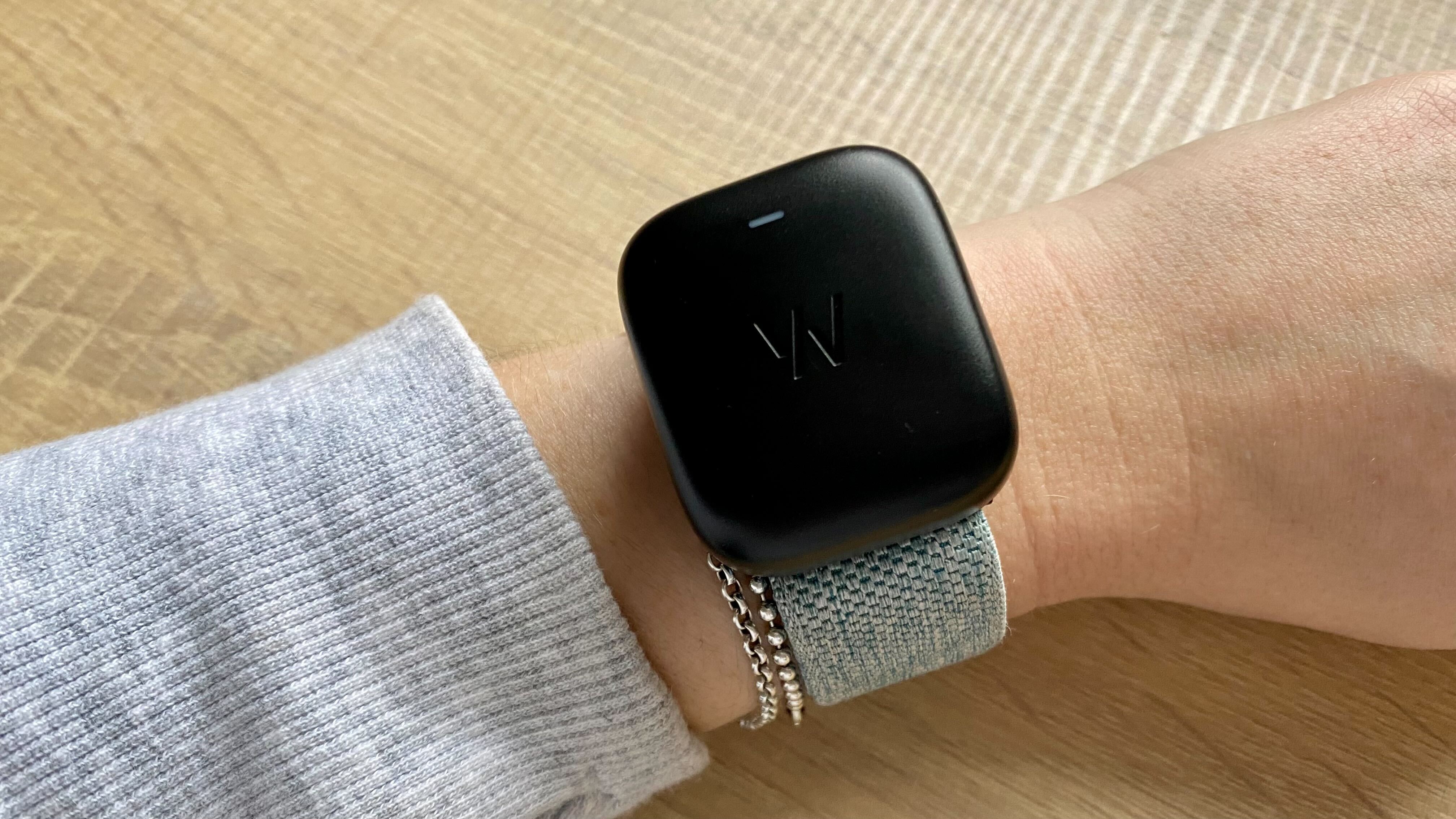 A photo of the Whoop wristband with charger