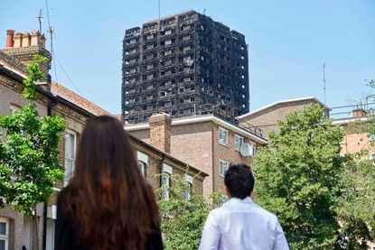 People looking at Grenfell Tower.