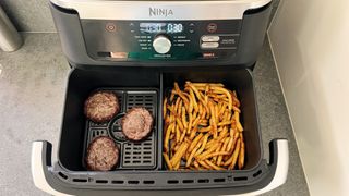 Ninja Foodi DualZone FlexBasket cooking burgers and fries