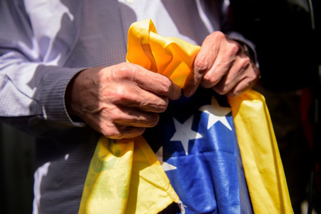 Man grips Venezuelan flag