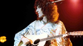 Queen’s Brian May playing guitar onstage in the mid-70s