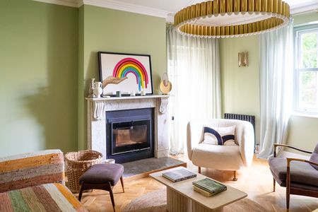 green living room with big light from the ceiling