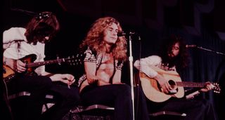 Led Zeppelin live onstage in Japan, 1971, with Jimmy Page [far-right] on acoustic guitar