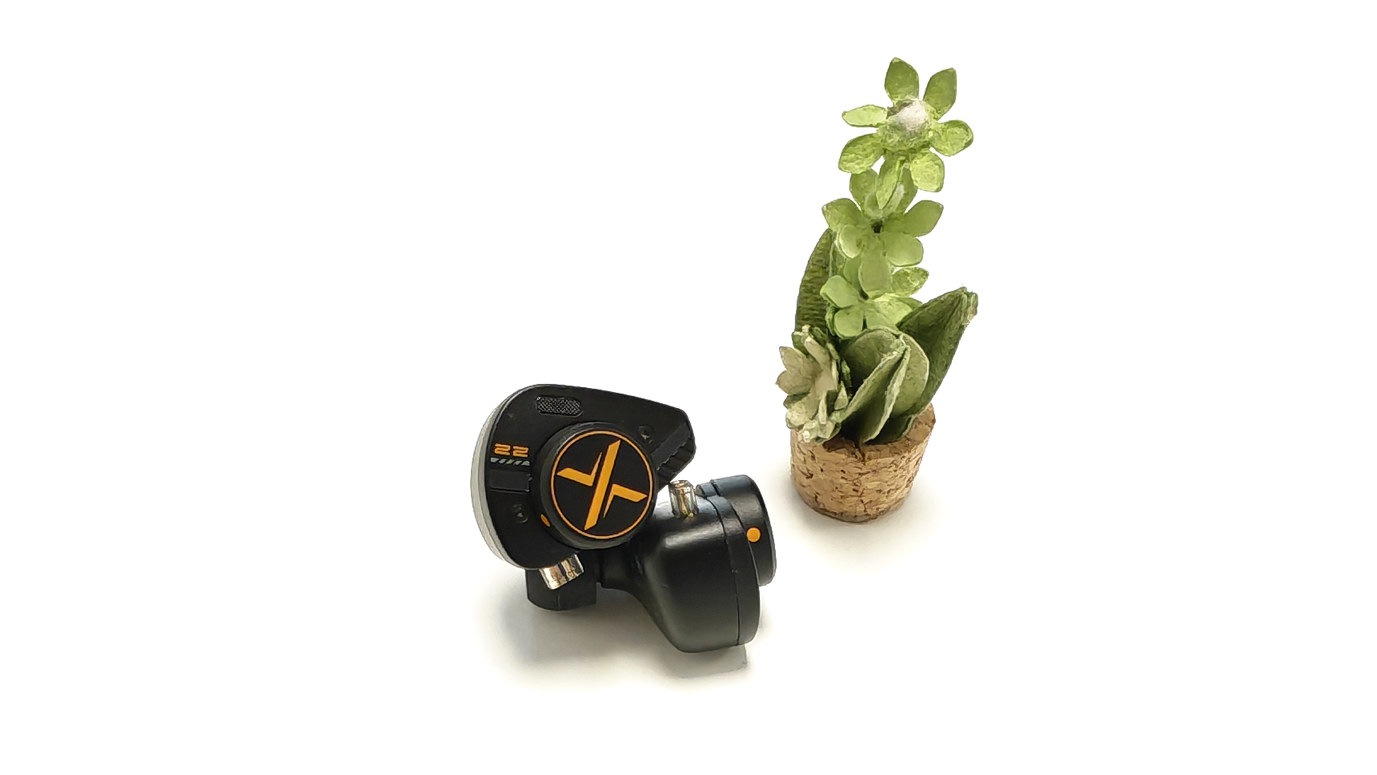 The OoopusX Op.22 earphones on a white desktop.