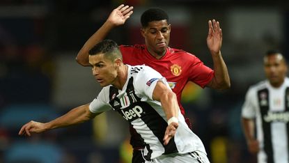 Juventus striker Cristiano Ronaldo battles with Manchester United’s Marcus Rashford