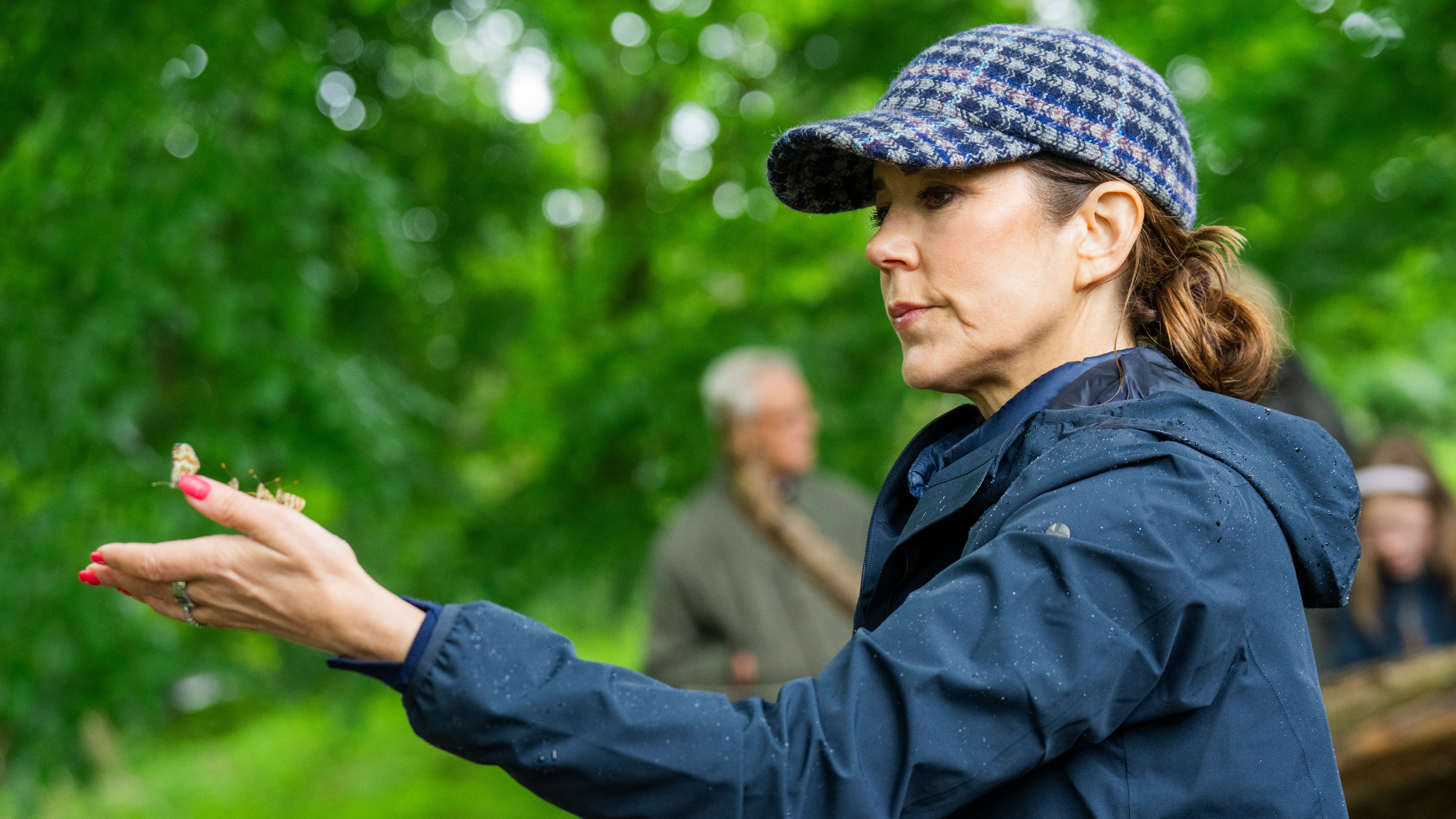 Queen Mary of Denmark releases butterflies in the forest as the Queen visits the WWF Nature Project at Knudshoved Odde on May 27, 2025