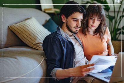 serious couple looking at energy bills in front of their laptop