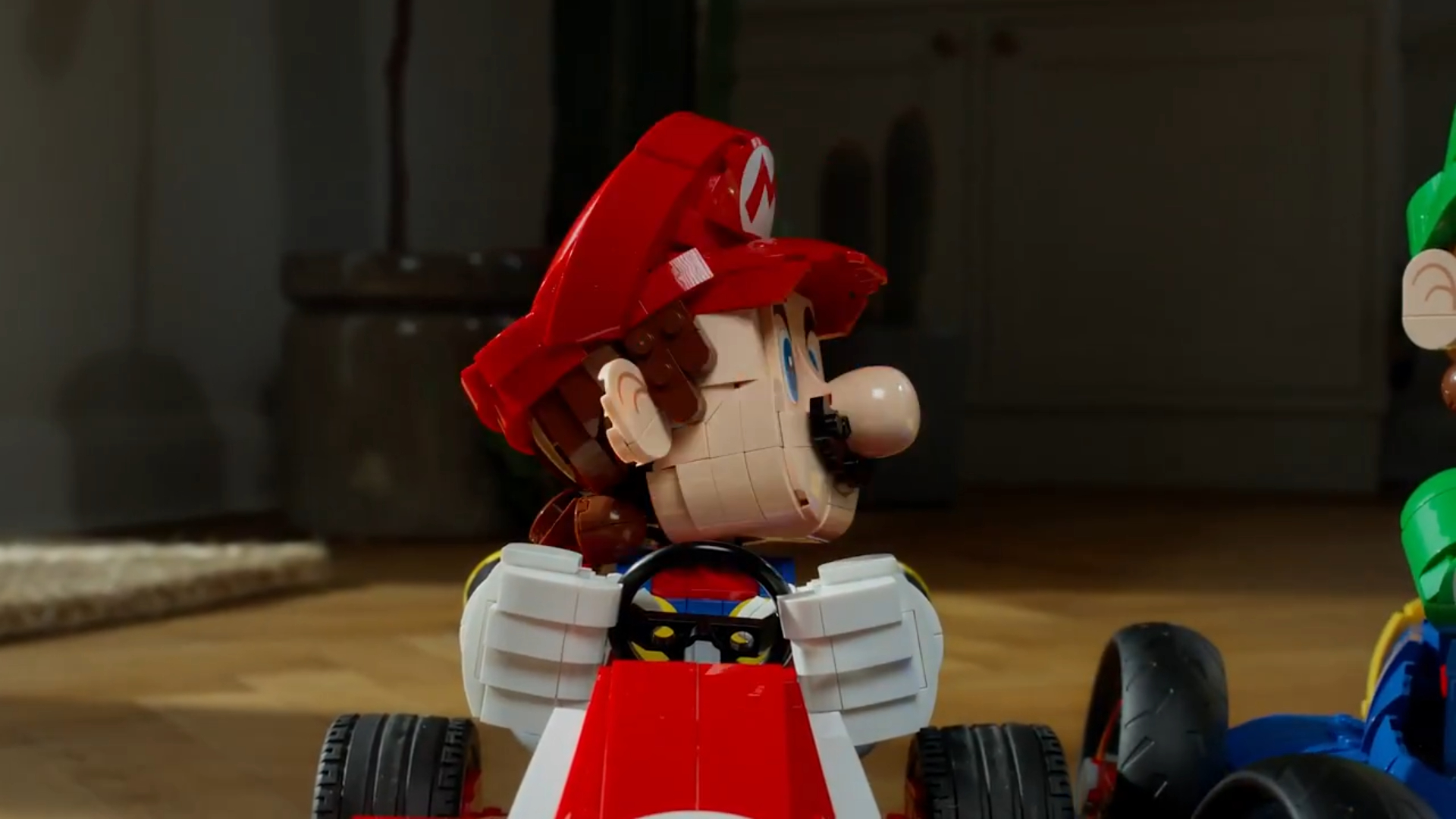 Lego Mario in Kart turns to look at a Lego Luigi set, which is just off frame