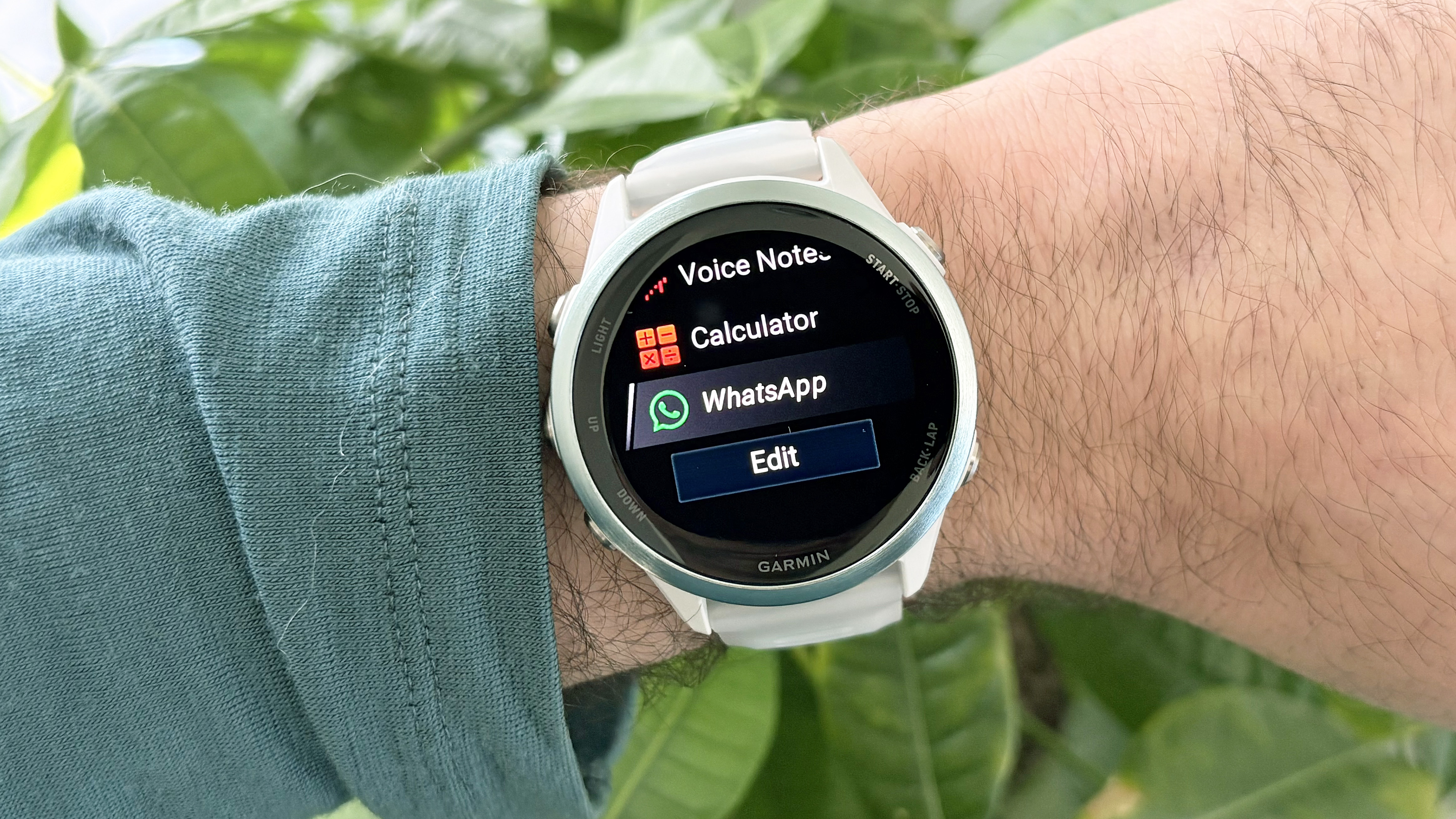 Garmin Forerunner 570 with WhatsApp shown on the screen
