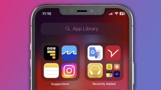 An iPhone on a pink and blue background showing the App Library