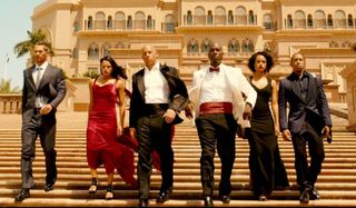 Furious 7 Brian, Letty, Dom, Roman, Ramsey, and Tej walking down steps in Abu Dhabi