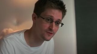 A closeup of Edward Snowden wearing a white tee shirt in Citizenfour