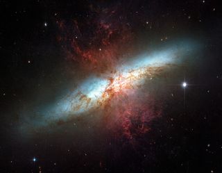 Plumes of glowing hydrogen blast from the center of M82, a well known galaxy undergoing a torrent of star formation. This mosaic of six images taken in 2006 by the Hubble Space Telescope is the sharpest ever obtained of the entire galaxy.
