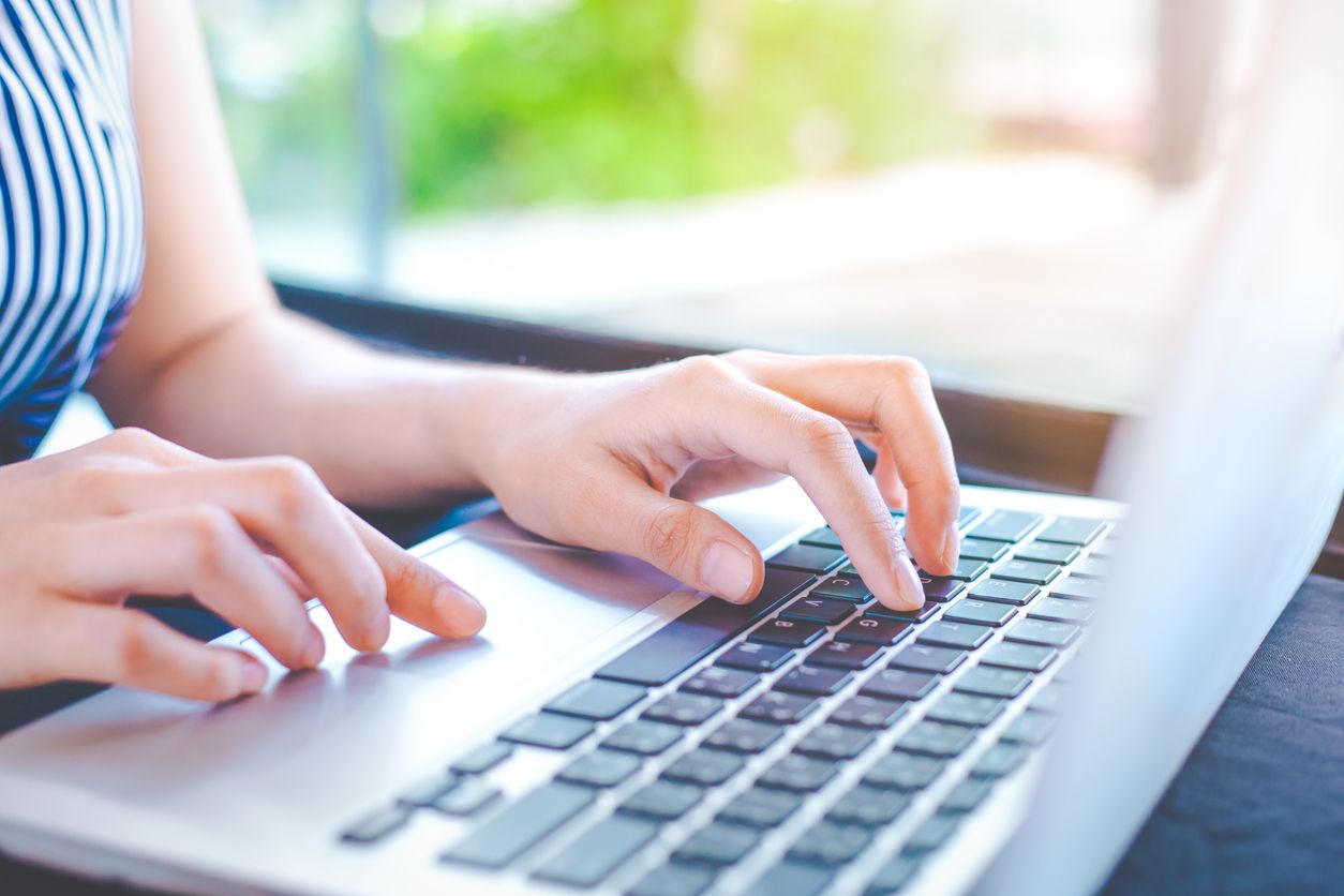 A girl typing on a laptop.