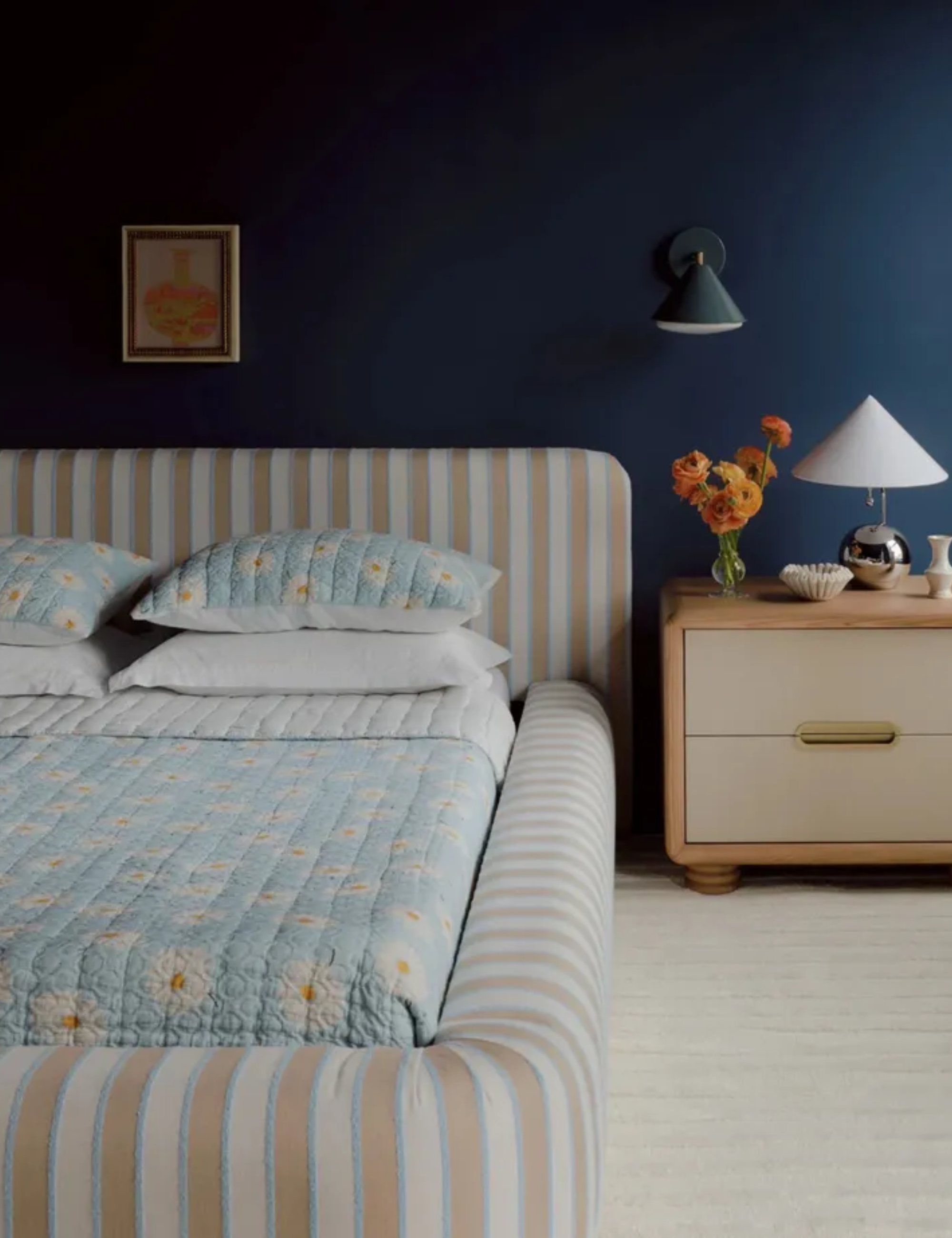 bedroom from the anthropologie artful aesthete bedroom with a beige and blue striped upholstered bed and chrome decor