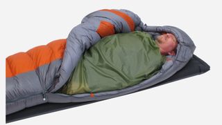 reasons you need a sleeping bag liner: Man inside a sleeping bag liner
