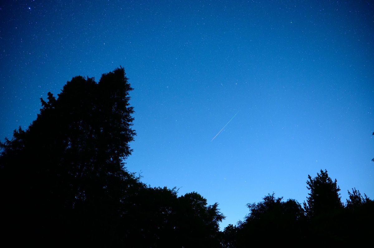 Meteor flashes across the night sky during the Perseid Meteor Shower 2026
