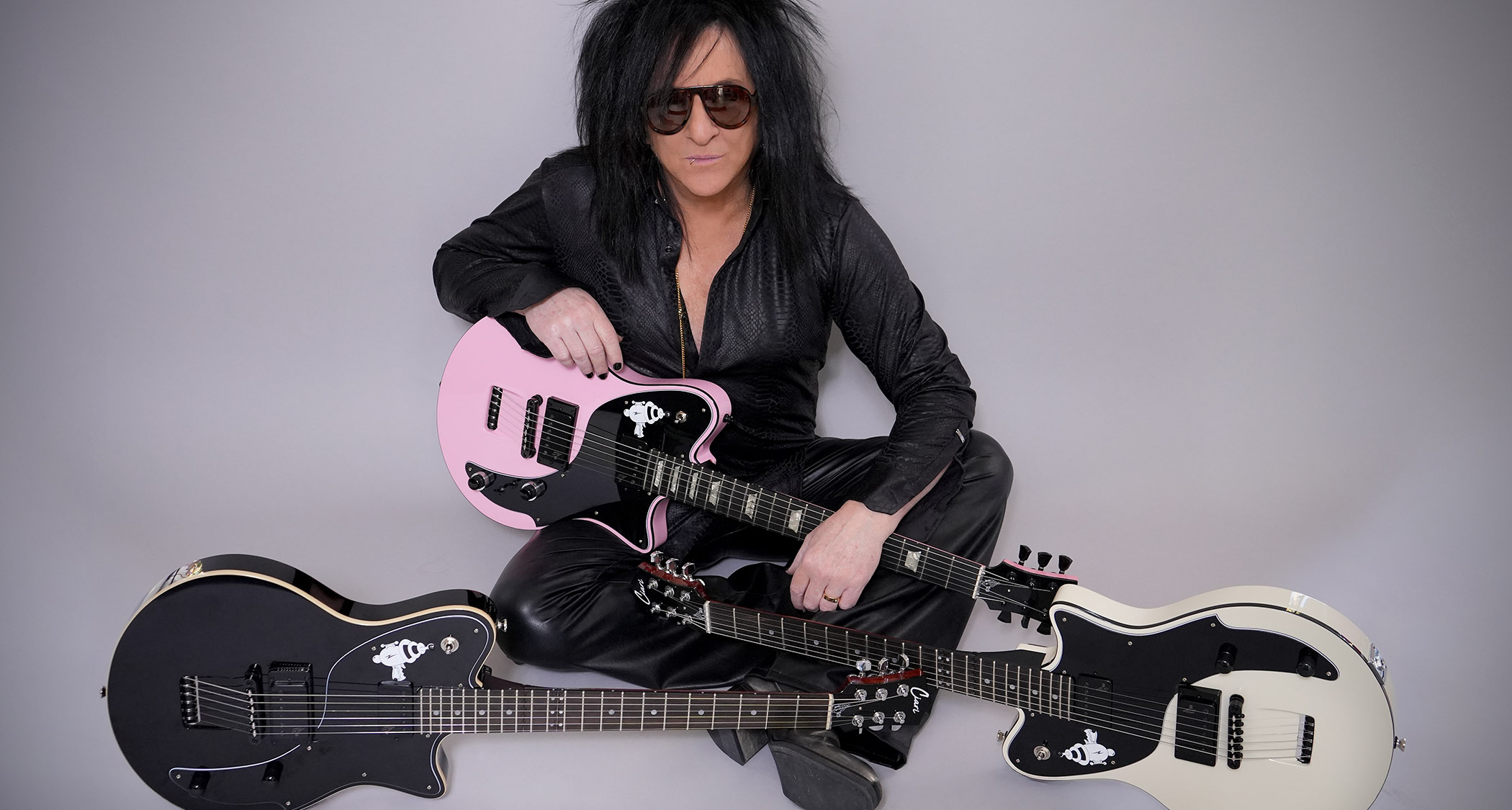 Steve Stevens poses with his new Ciari signature guitar; a fold-away travel-friendly electric that comes in pink, black and white.