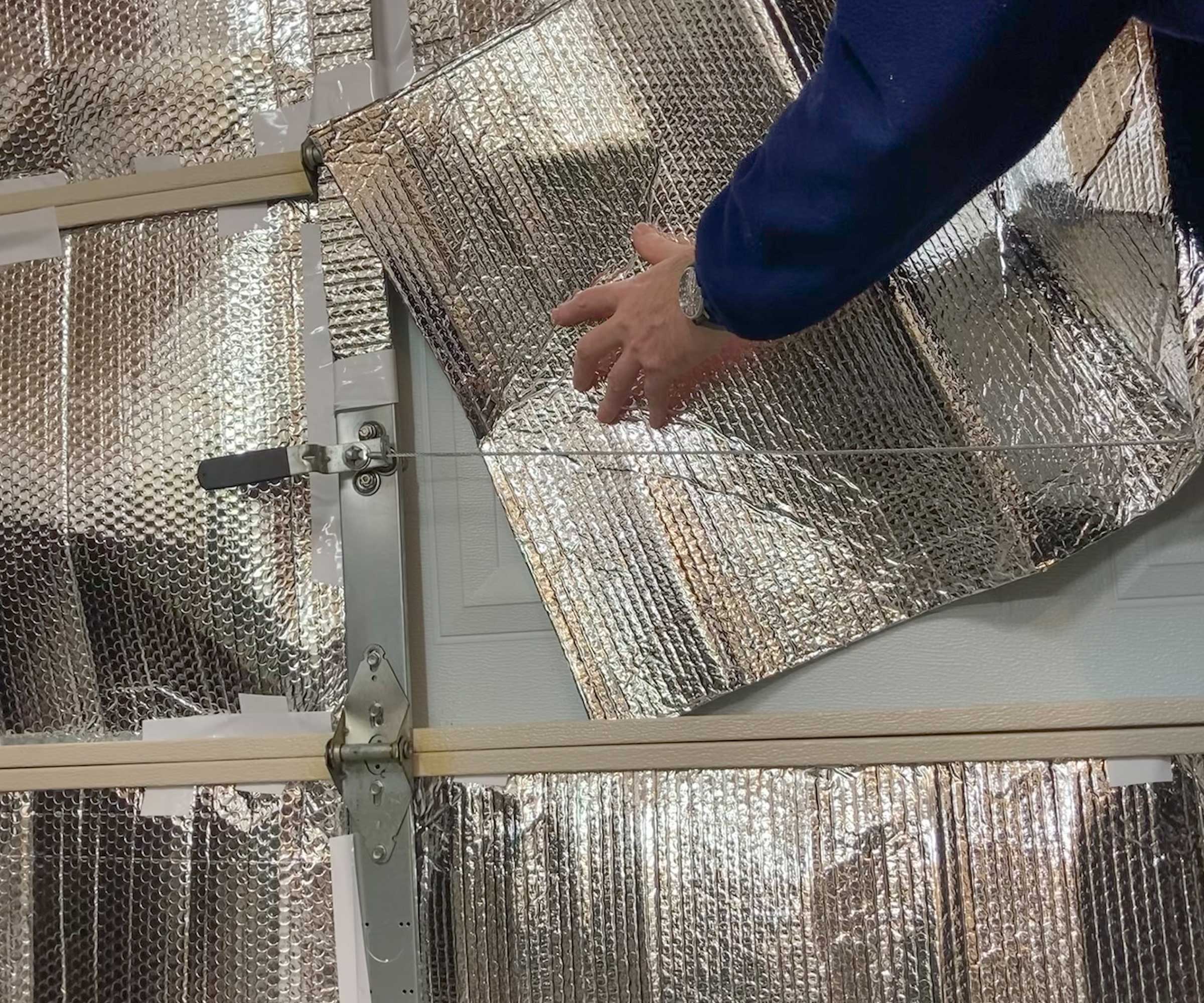 foil insulation being added to the inside of a garage door