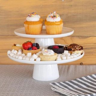 A double-tiered white cake stand