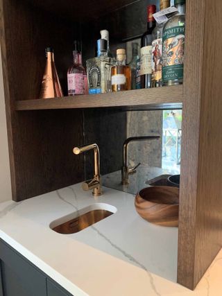 a kitchen with a bar and small drinks sink