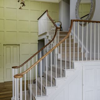 Hallway with floor to ceiling wall panelling painted light green