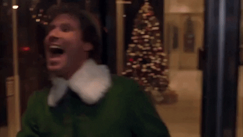 Will Ferrell as Buddy the Elf runs around a revolving door