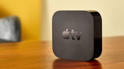Apple TV on brown wooden table