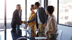 Businesspeople shaking hands in conference room