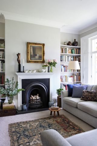 A living room in a Regency townhouse with fireplace and patterned rug
