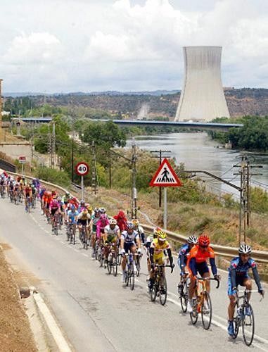 The peloton rides past a nuclear power station during the second stage of the race.